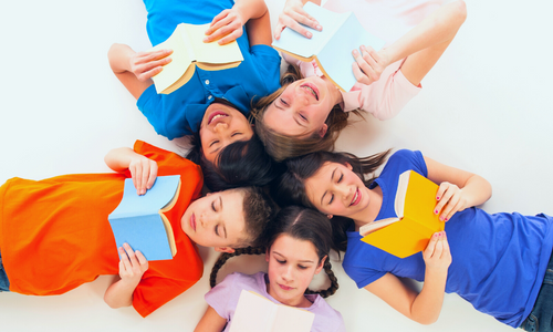 Kids laying in a circle and reading books