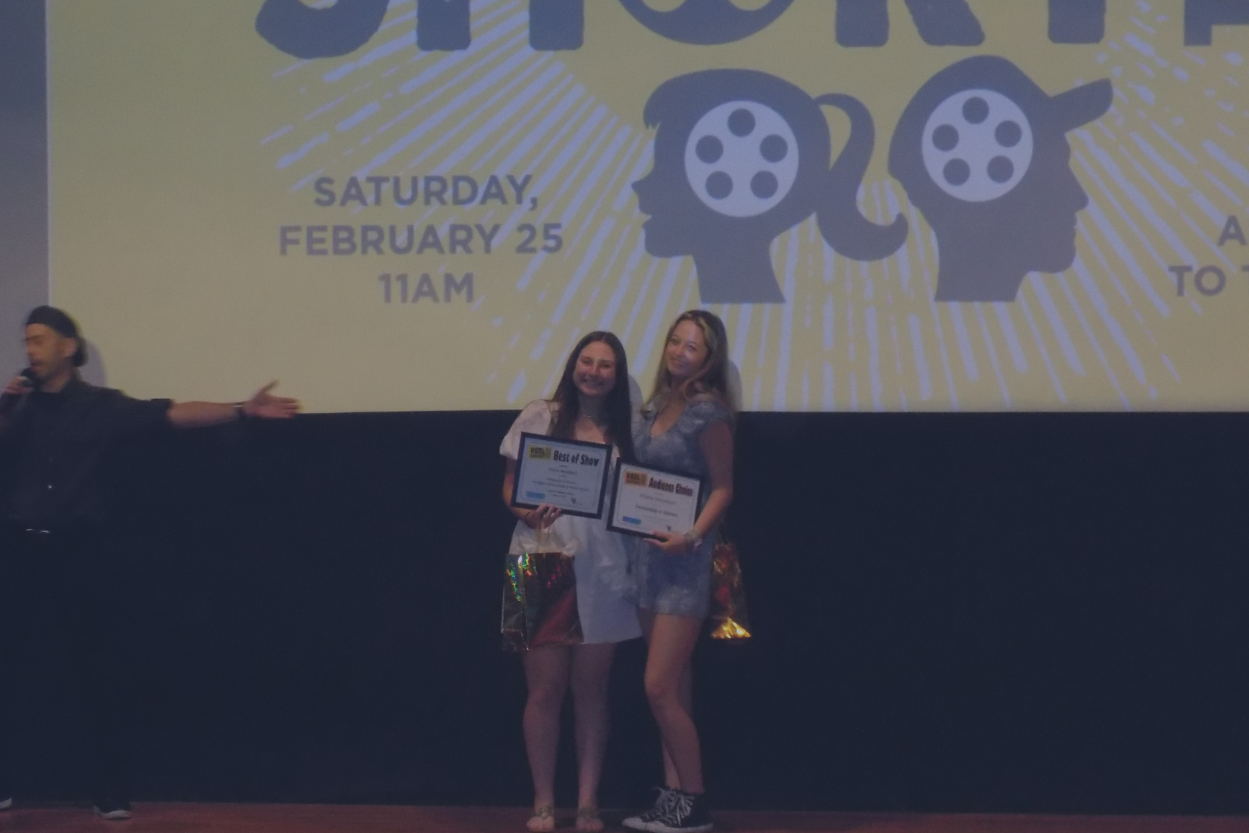 Two students holding certificates